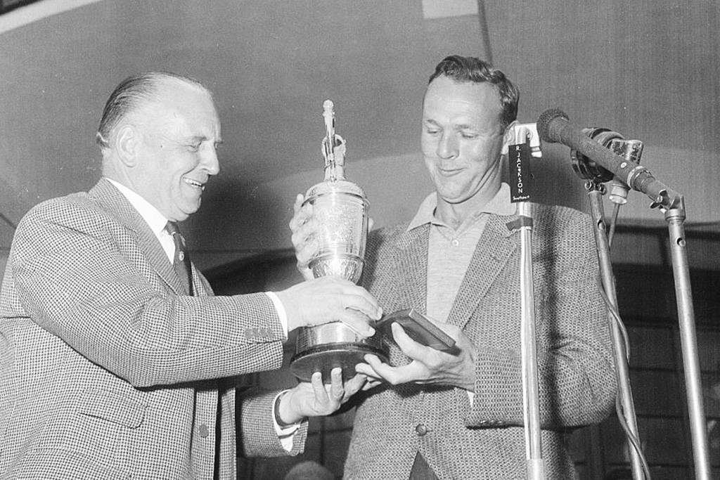 Arnold Palmer lifts the Claret Jug after winning The Open in 1961